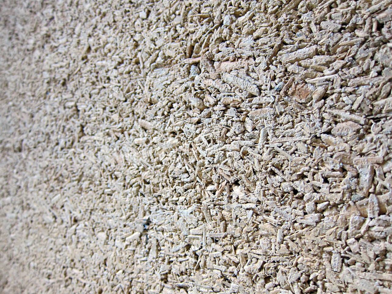 A section of hemp concrete wall, showing the plant fibres in the lime binder.