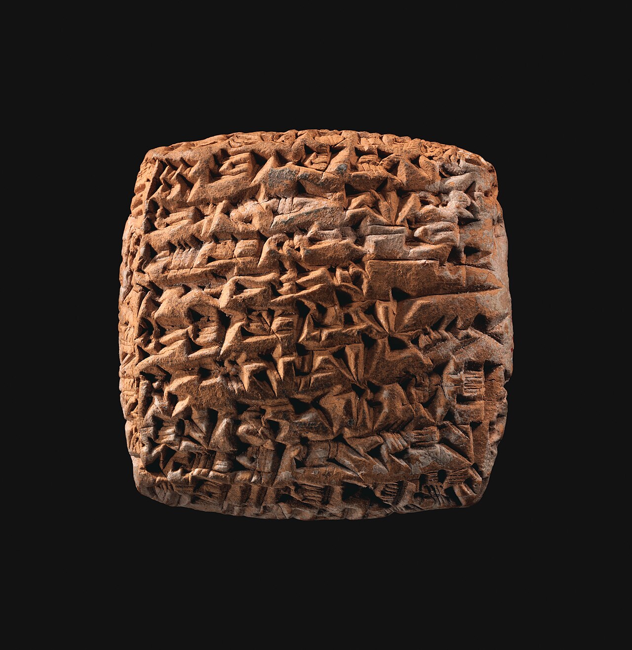 A small clay tablet covered in cuneiform script recording a loan of silver.