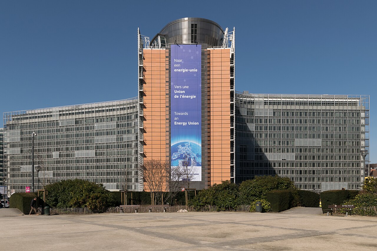 The Berlaymont building in Brussels, seat of the European Commission, under a clear blue sky.