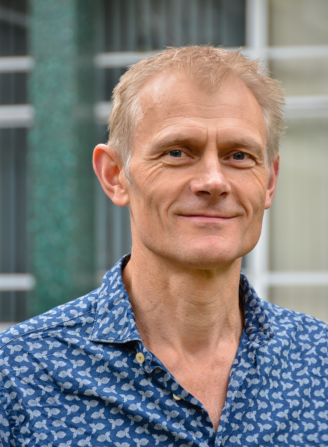 Portrait of climate scientist Kevin Anderson in a blue patterned shirt.