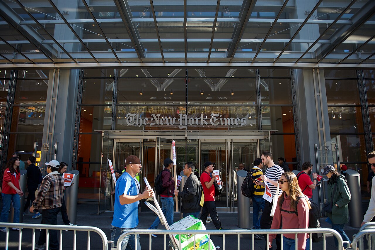Striking tech workers with picket signs outside the New York Times building.