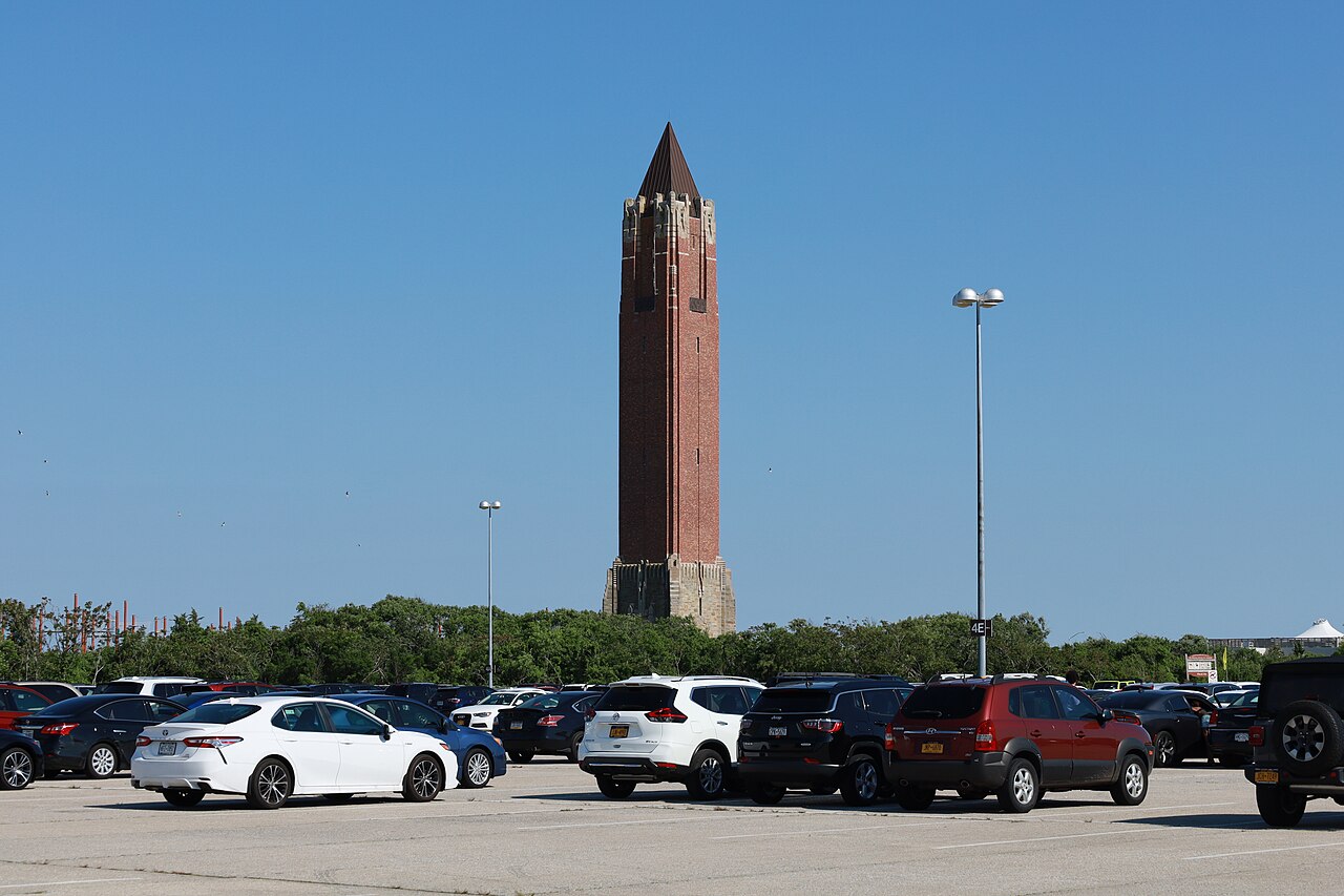 The brick water tower of Jones Beach State Park rises above a full car park.