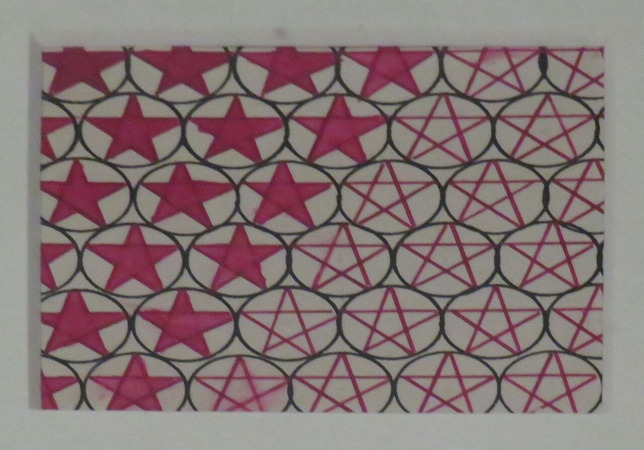 Popova's fabric design of red stars inside overlapping black circles.